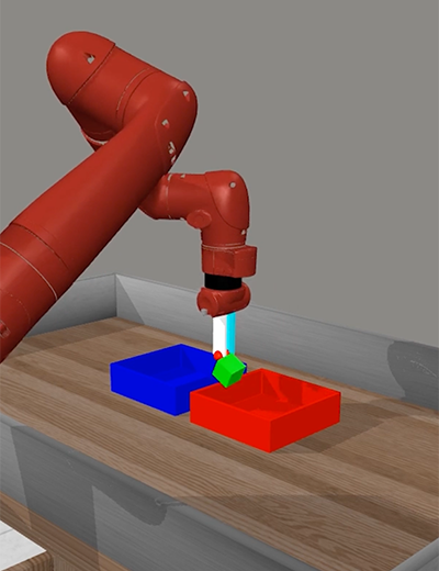Robot moving green block into a blue box