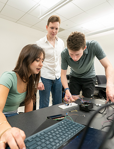 students working together on a piece of hardware