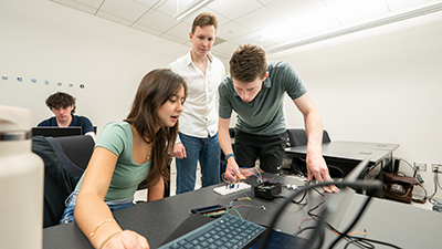 students working together on a piece of hardware