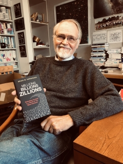 Brian Kernighan holding a copy of his new book