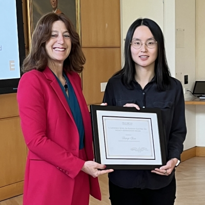 Andrea Goldsmith presenting the framed award to Danqi Chen.