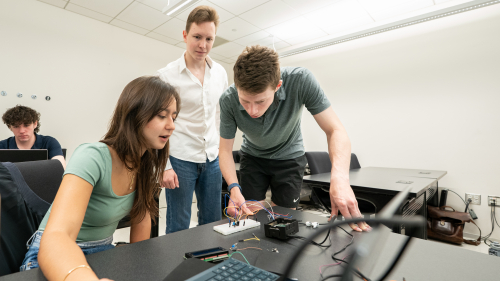 students working together on a piece of hardware
