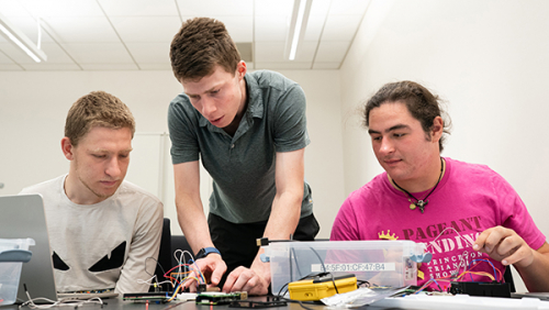students working together on a piece of hardware