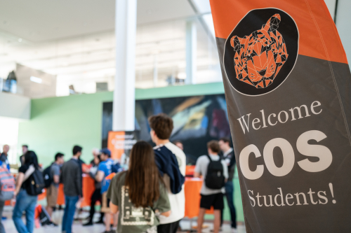 COS banner with students in the background