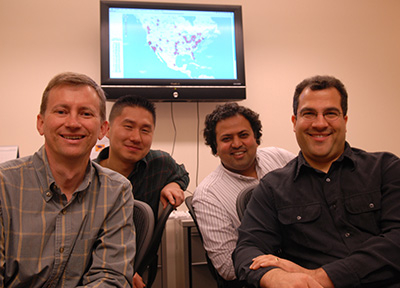 Four researchers sitting together, smiling