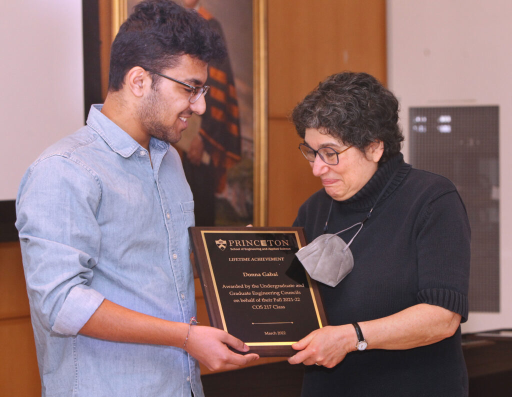 Dwaipayan Saha presenting a lifetime achievement teaching award to Donna Gabai.